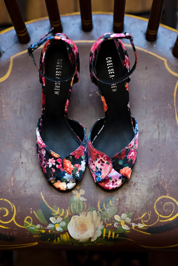 Colorful wedding shoes on a vintage chair.